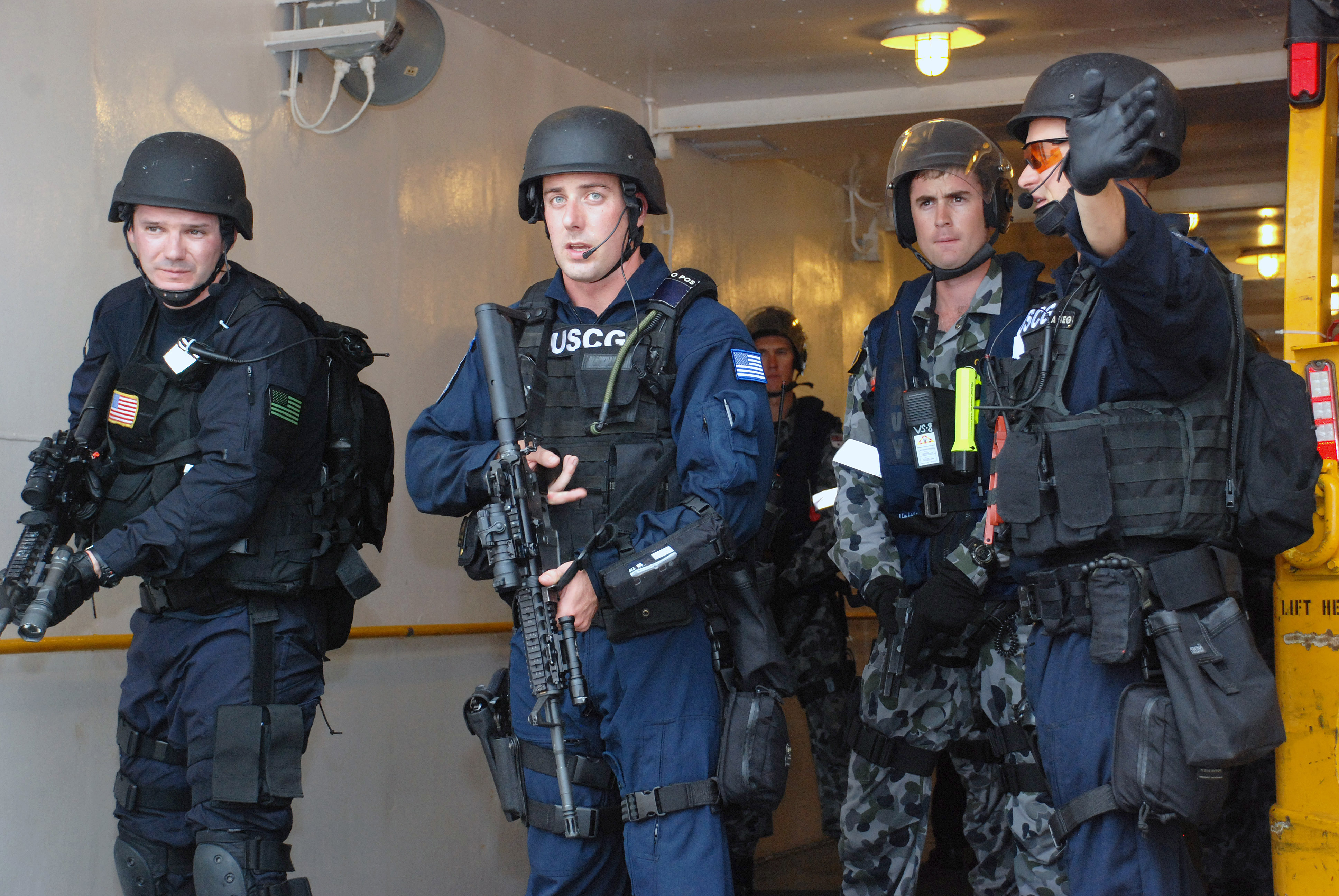 US Navy 091029-N-7095C-112 Lt. Colin Turner, assigned to U.S. Coast Guard Maritime Safety and Security Team San Diego (91109), directs a joint boarding team during an exercise aboard the Military Sealift Command fleet replenish.jpg